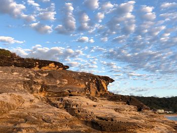 Rock formations on landscape against sky