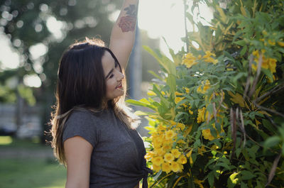 Young woman standing amidst plants