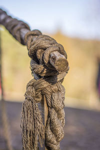 Close-up of rope tied up against sky