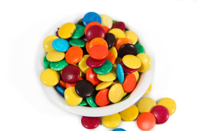 Close-up of multi colored candies against white background