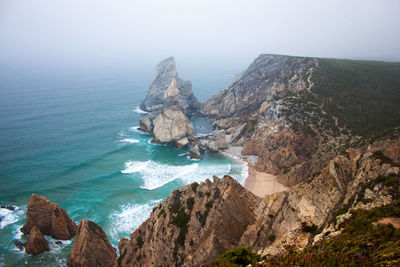 Panoramic view of sea and mountains against sky