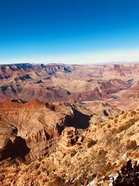 Scenic view of mountains against clear blue sky