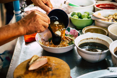 Midsection of person preparing food on table