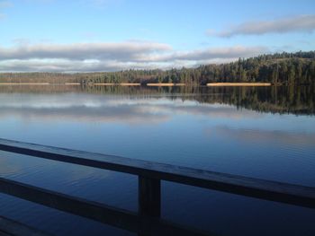 Scenic view of swimming pool by lake against sky