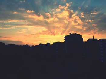 Silhouette of building against sunset sky