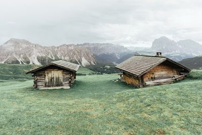Old house on mountain against sky