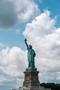 Low angle view of statue against cloudy sky