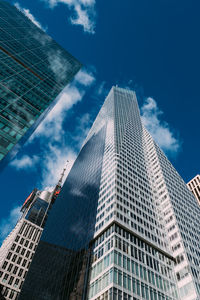 Low angle view of modern buildings against sky in city