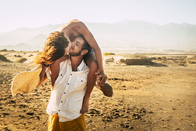 Young couple standing on beach