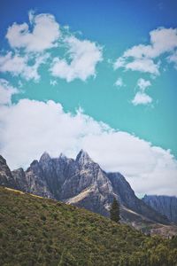 Scenic view of mountains against cloudy sky