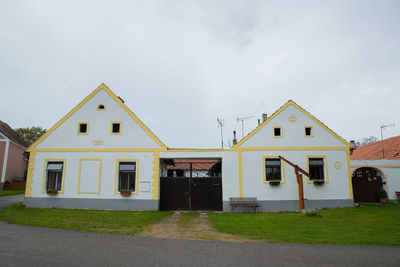 Houses by street against sky in city