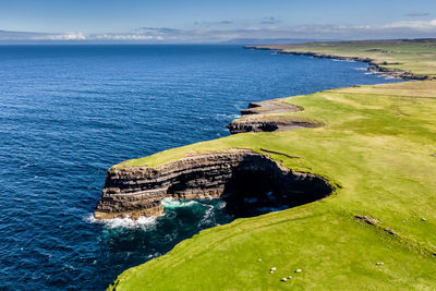 High angle view of rocks by sea against sky