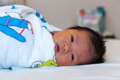 Close-up cute baby sleeping on bed