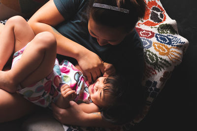 High angle view of mother and daughter playing at home