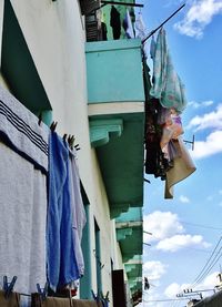 Low angle view of clothes drying on clothesline against sky