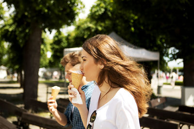 Friends eating ice cream in city
