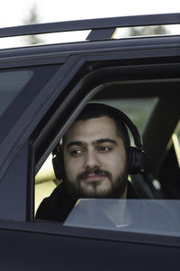 Portrait of young man in car