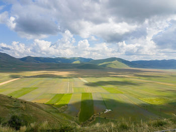 Scenic view of mountains against cloudy sky