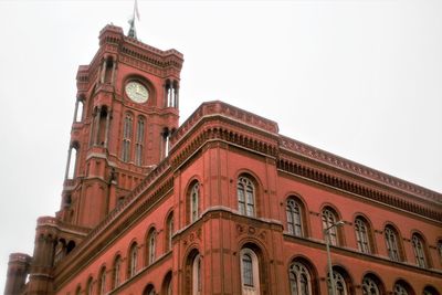 Low angle view of clock tower against sky