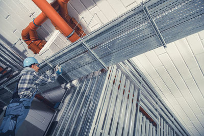 Low angle view of man working in building