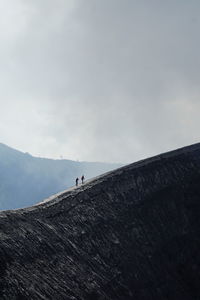 Man on mountain against sky