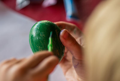 Close-up of woman painting easter egg