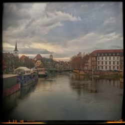 Boats in river with buildings in background