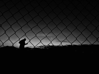 Silhouette of man standing on field against sky