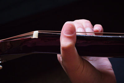 Close-up of person playing guitar