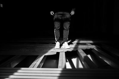 Low section of person standing on wooden floor