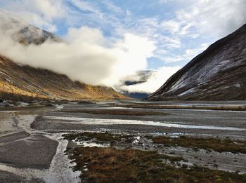 Scenic view of lake against cloudy sky