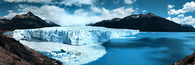 Panoramic view of frozen lake against sky