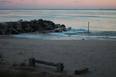 Scenic view of beach against sky during sunset