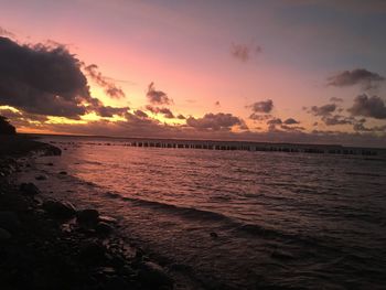 Scenic view of beach against sky during sunset