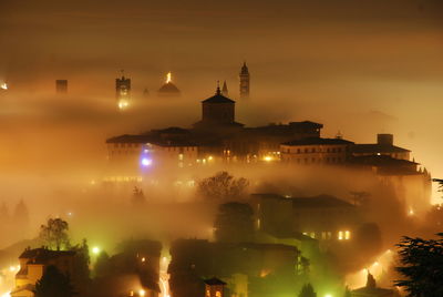 Illuminated buildings in city at night