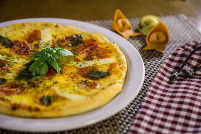 High angle view of pizza in plate on table