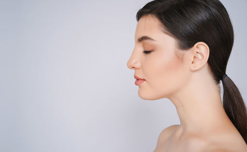 Portrait of a beautiful young woman over white background