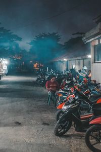 People riding motorcycle on road at night