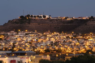 High angle view of illuminated buildings in city at night