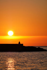 Scenic view of sea against romantic sky at sunset