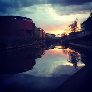Scenic view of river with buildings in background