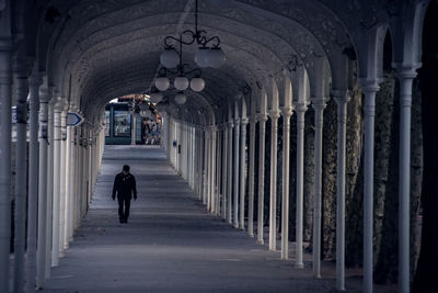 Full length of man walking in covered walkway