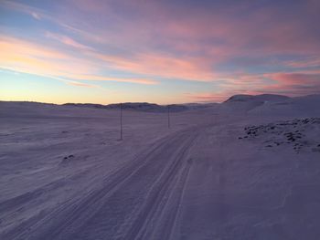 Scenic view of desert against sky during sunset