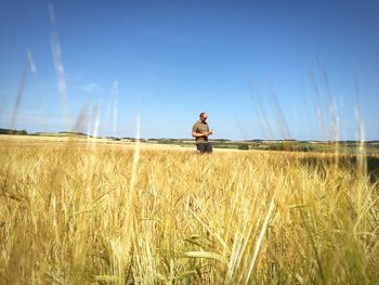 Man on standing on field against sky