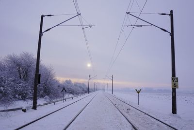 Snow covered road against sky