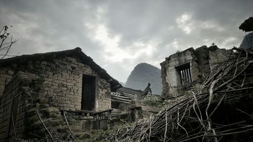 Buildings against cloudy sky