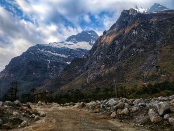 Scenic view of mountains against cloudy sky