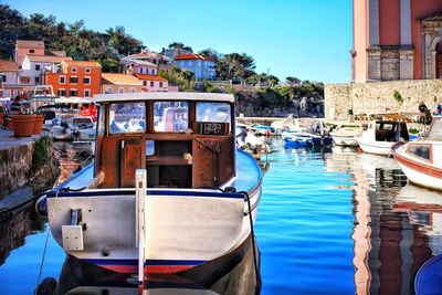 Boats in water against blue sky