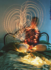 Close-up of illuminated chandelier on table at home