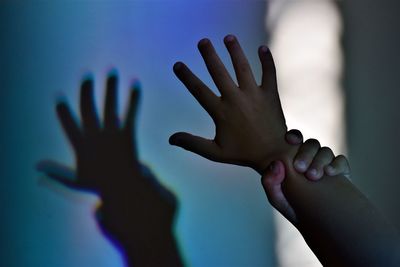Close-up of hands touching finger